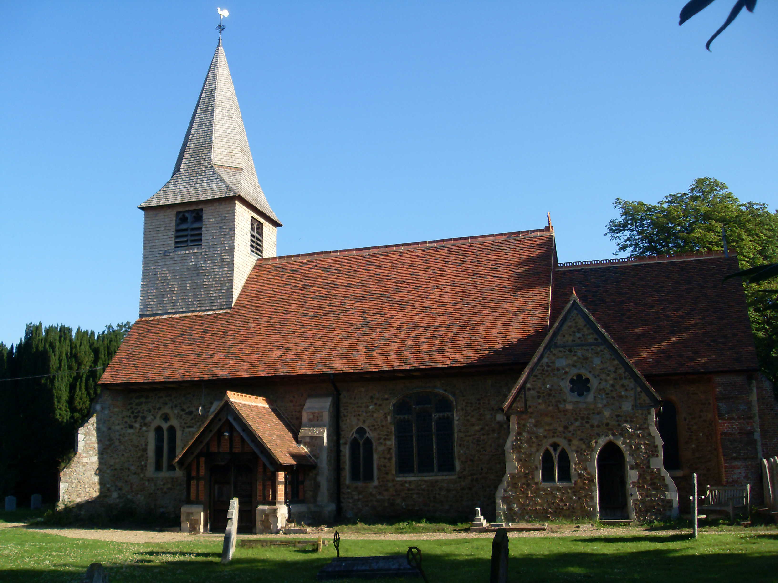 St Peter's Church, Great Totham — flint walls, timber porch, shingled spire